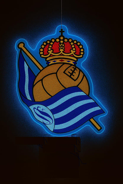 Escudo de futbol liga 2º division del Club REAL SOCIEDAD, Diseño con medidas metacrilato 40x35cm aproximadamente dependiendo el diseño del escudo con neon led,metacrilato y vinilo color.Alimentacion 12v,cable 2m y cadena para colgar en pared incluido.